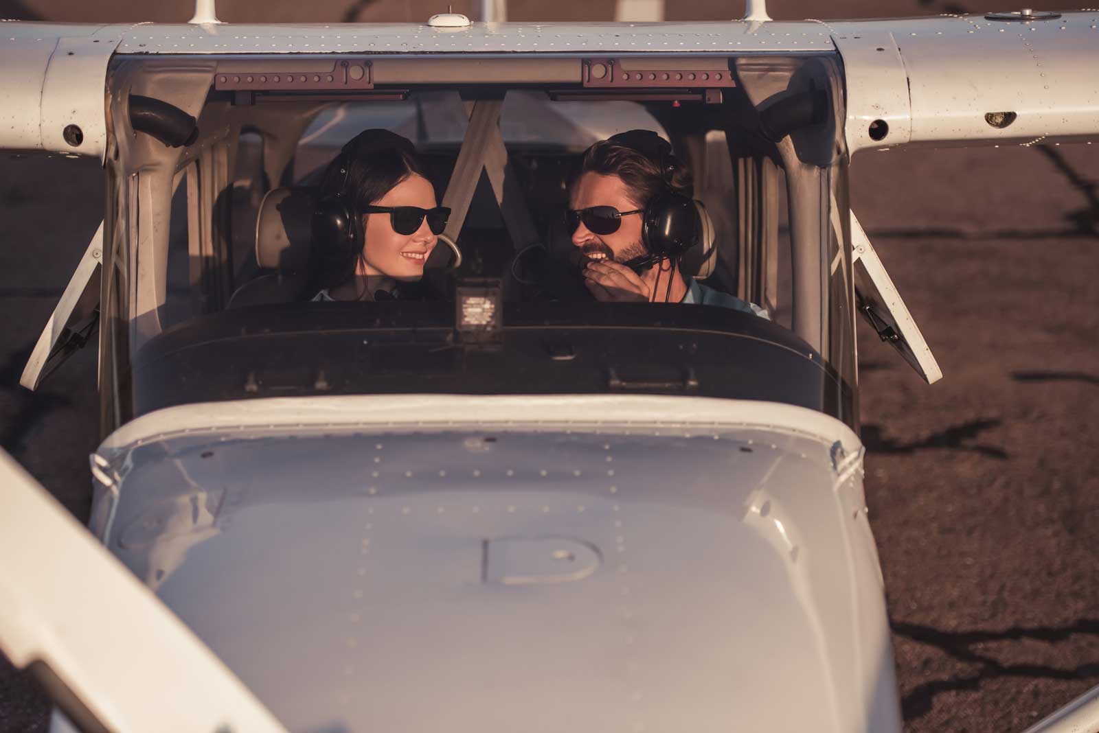 Student and instructor in a high-wing training airplane cockpit
