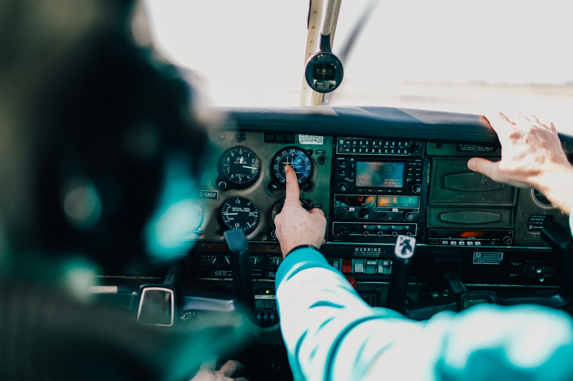 Instructor pointing to cockpit instruments during dual instruction